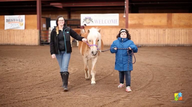 Gersh Academy Student and NYEC Employee walking a Horse